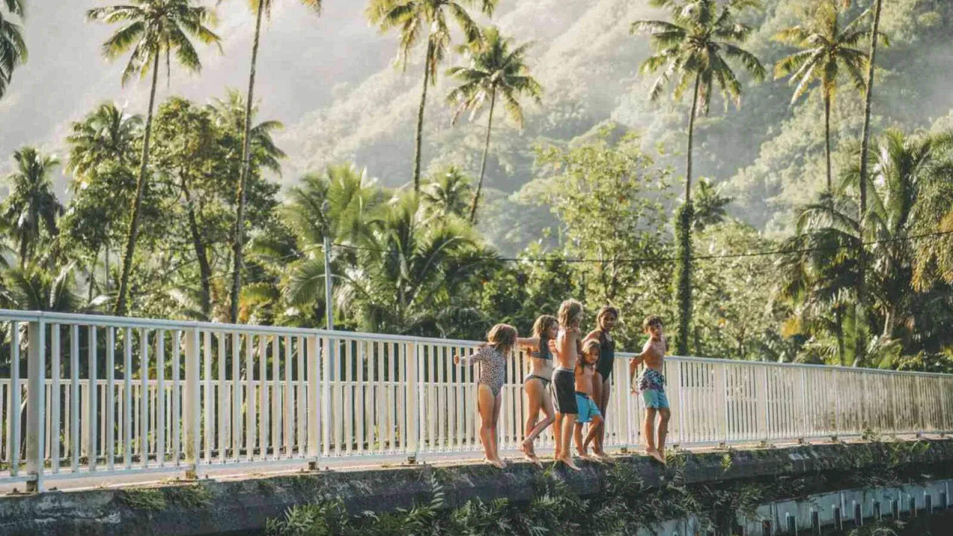 Children on the Faaone bridge about to jump into the river © Overpeek Studio